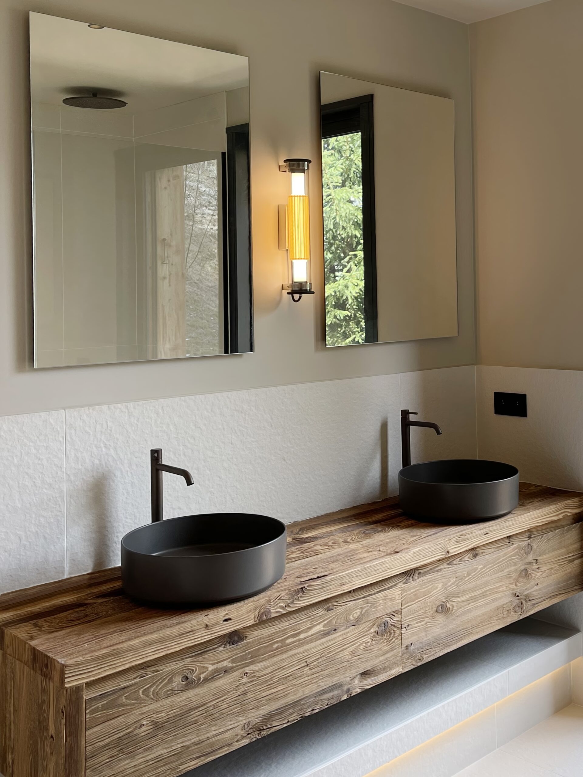 Décoration d'intérieur à Megève d'une salle de bain moderne avec vasque à poser et meuble en bois